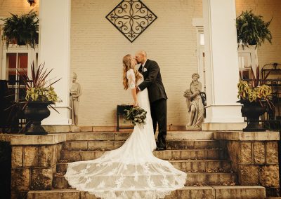 bride groom kiss on front steps Ludlow Mansion