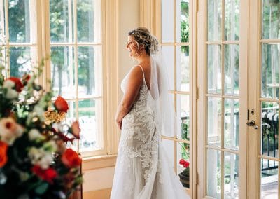 0101_Ludlow-Mansion-bride-by-glass-doors-smiling