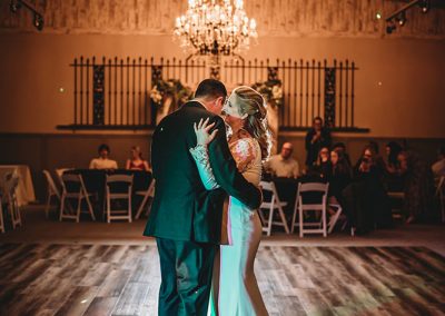 couple dance under chandelier Carriage Hall