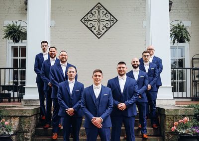 groomsmen standing on front porch